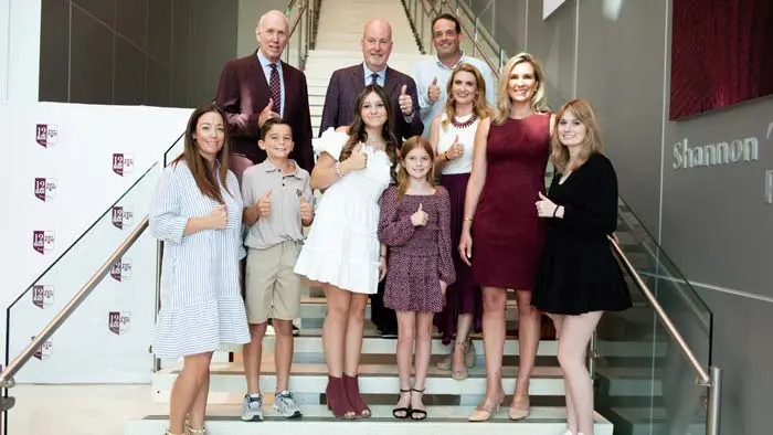 group of people posing on the stairs