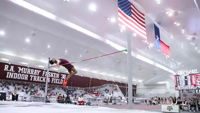 high jumper inside track facility jumping