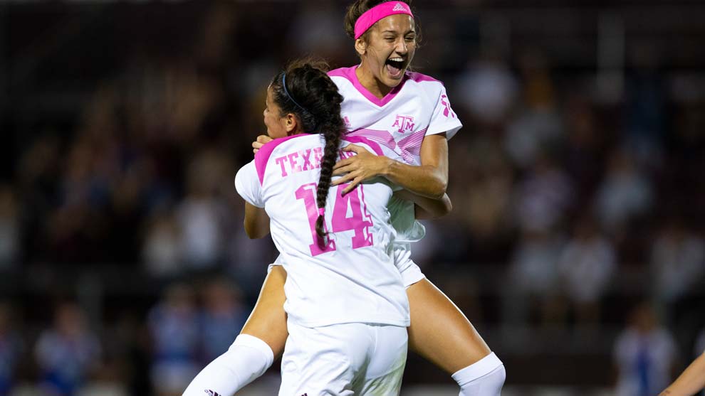 Two women's soccer players celebrating