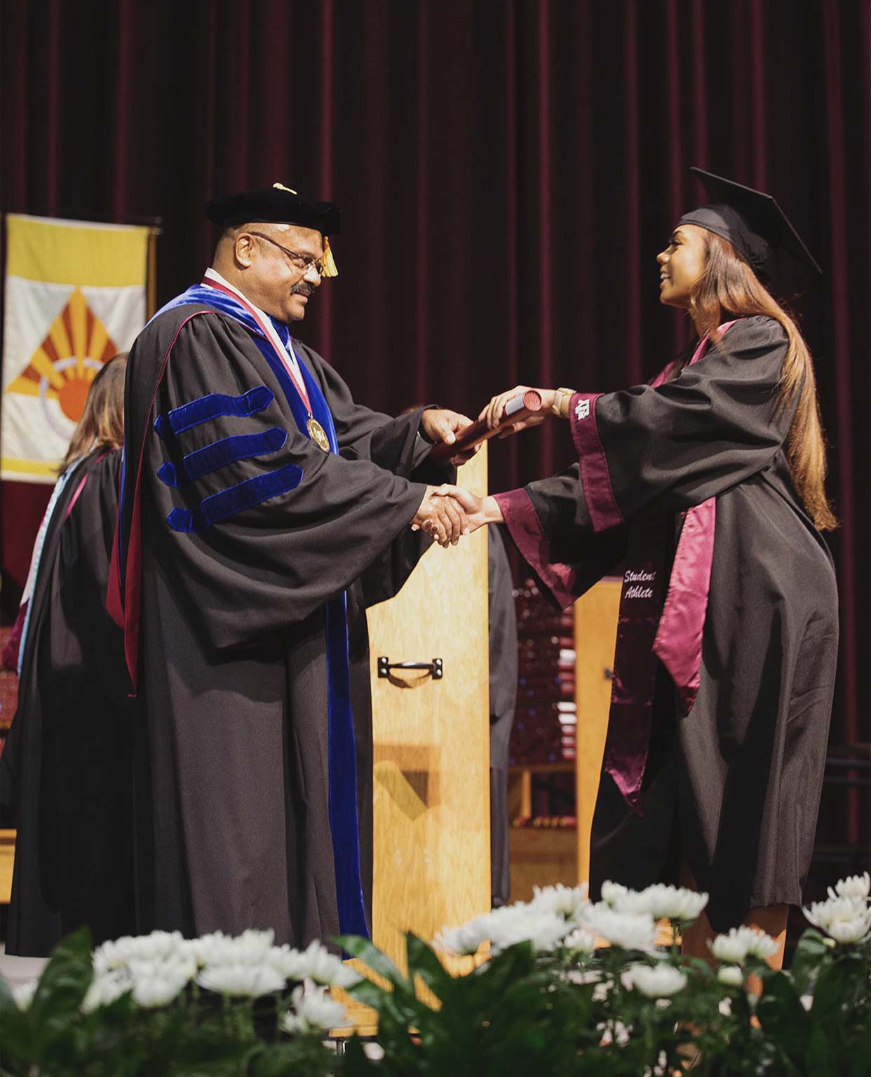 Ally Watt accepting her degree on stage during graduation