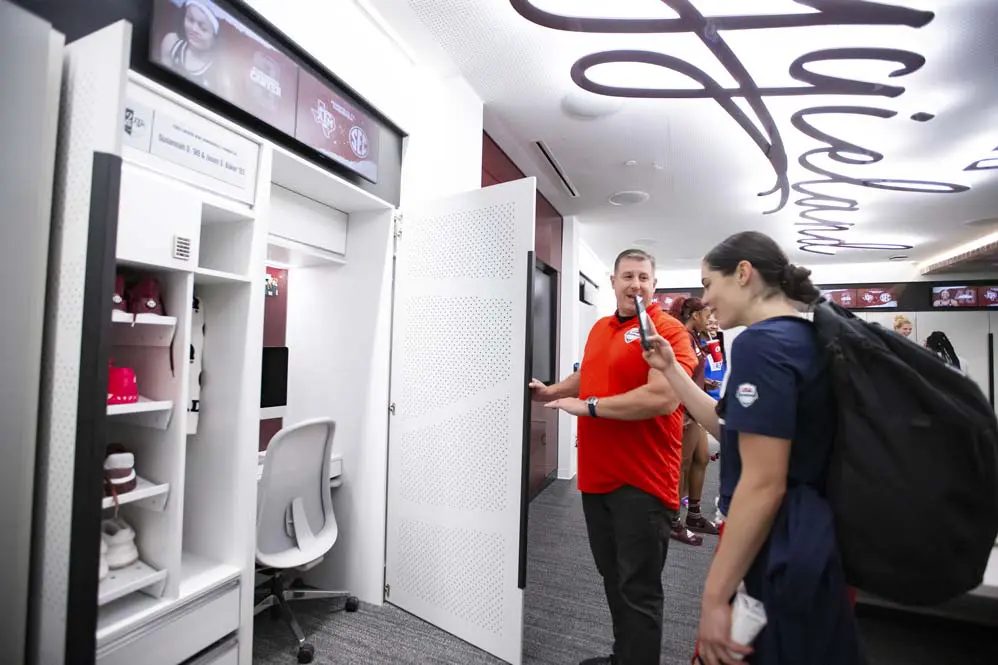 Someone taking a picture of a locker in the locker room