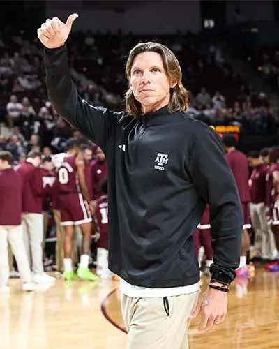 Portrait of Adam Sinn shaking hands