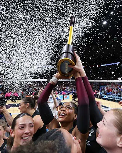 athletes holding trophy