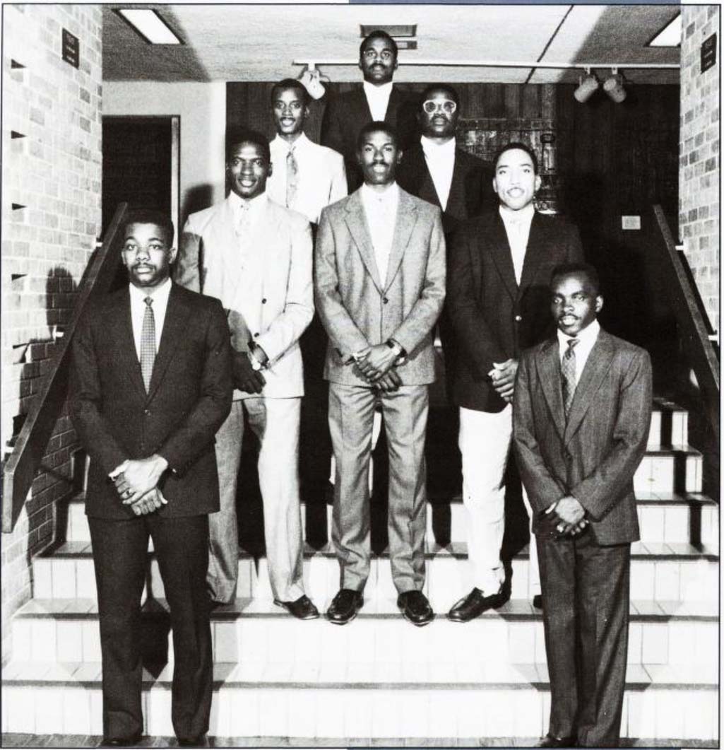 A group of men posing on steps