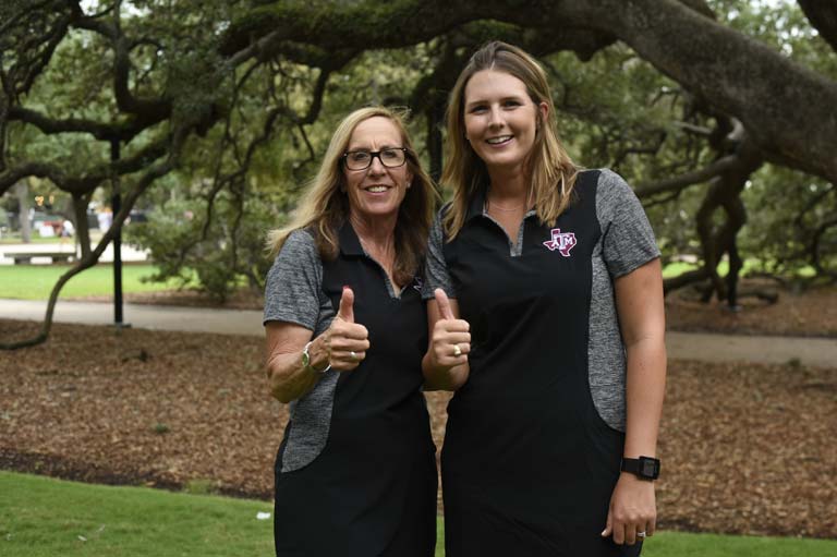 Two women giving thumbs up