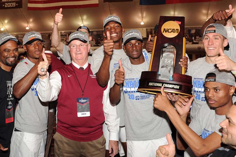 The men's track and field team posing with an NCAA trophy