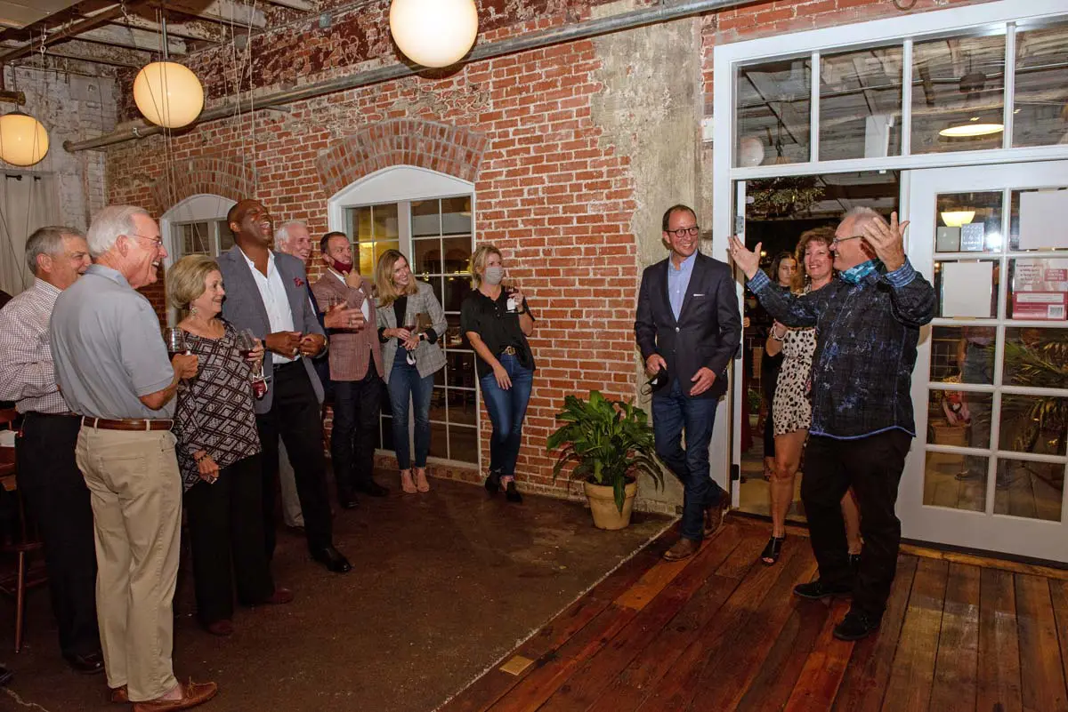 Rhonda & Frosty Gilliam Jr entering a room full of people