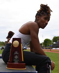 Tyra Gittens sitting with a trophy