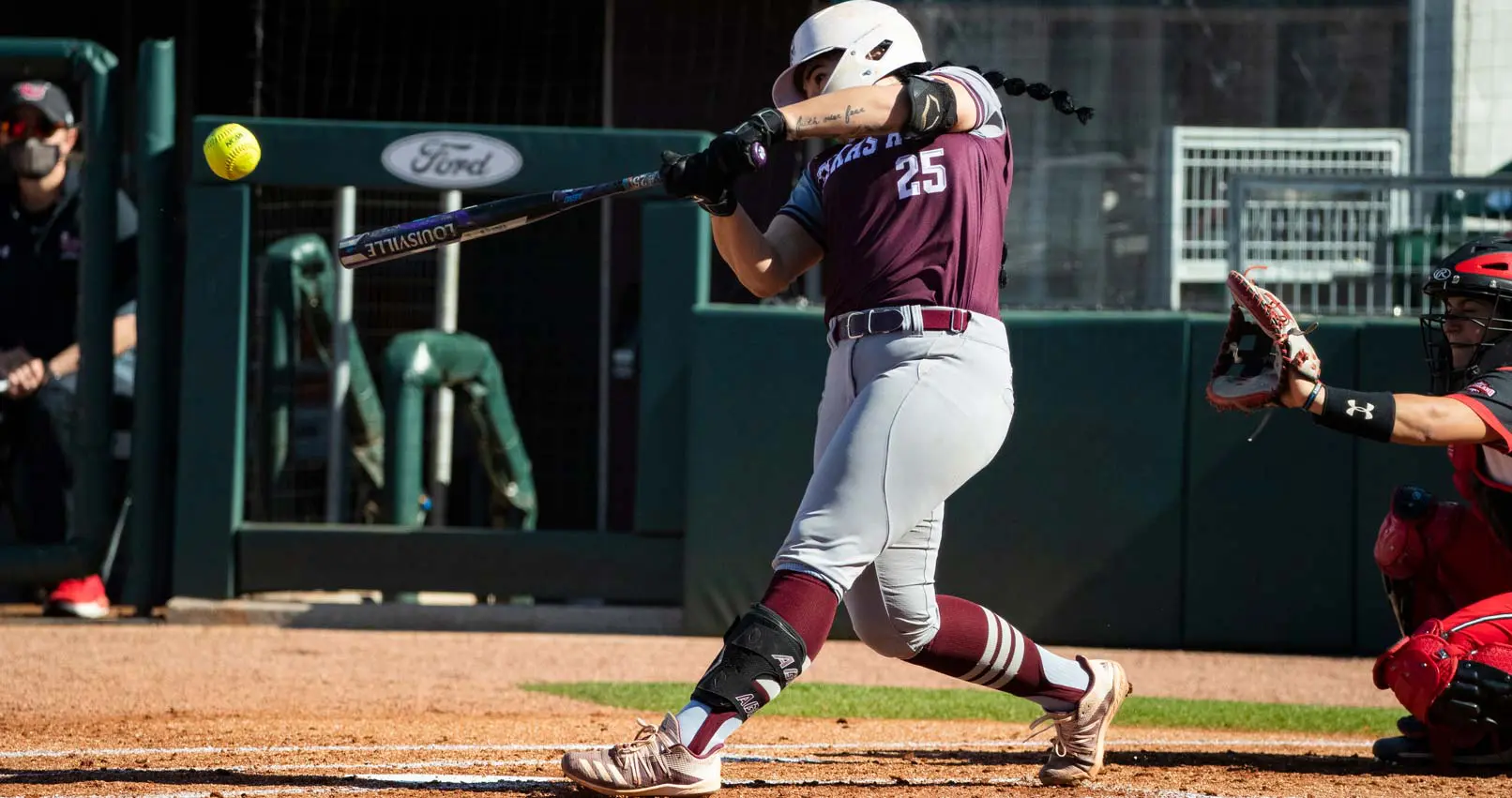 Haley Lee swinging at a softball during a game