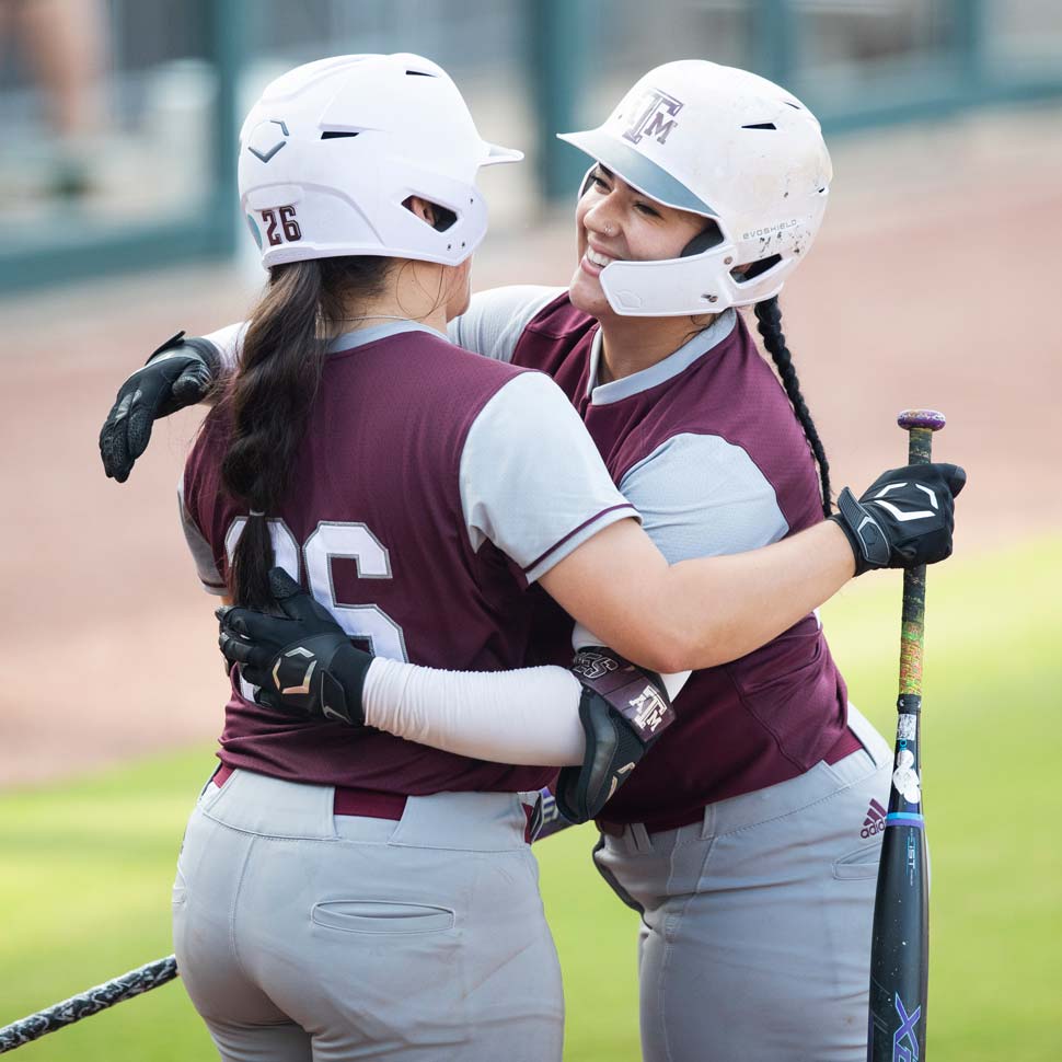 Haley Lee hugging a teammate on the field during a game