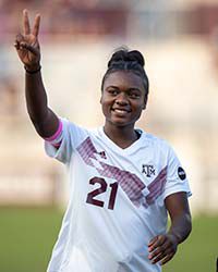 karlina Sample showing 'peace' sign on soccer field