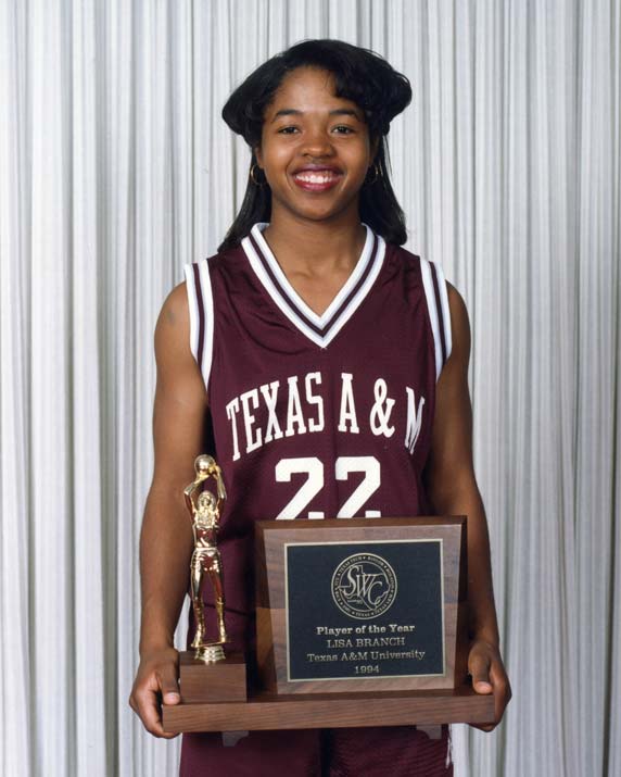 Lisa Branch in her basketball jersey holding a trophy