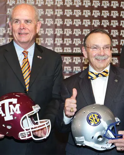 Portrait of Adam Sinn shaking hands