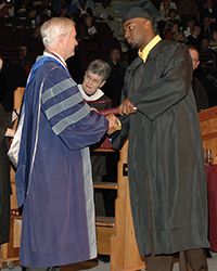 Terrence Murphy shaking a graduate's hand