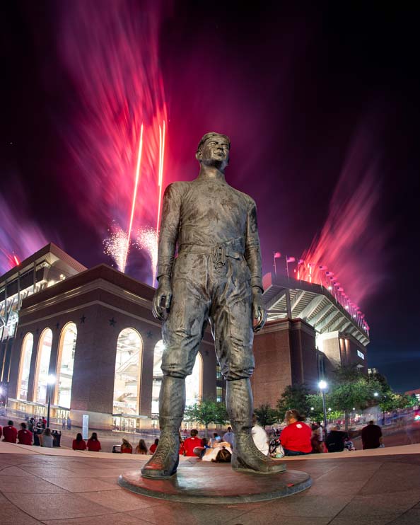 E. King Gill statue at night outside of stadium