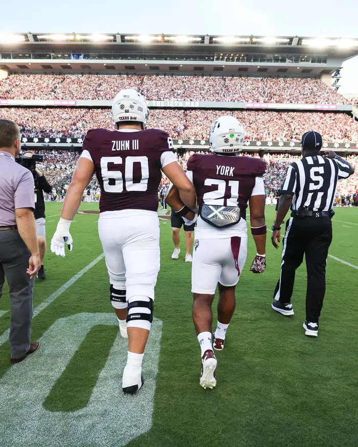 Taurean York in football gear walking onto the field