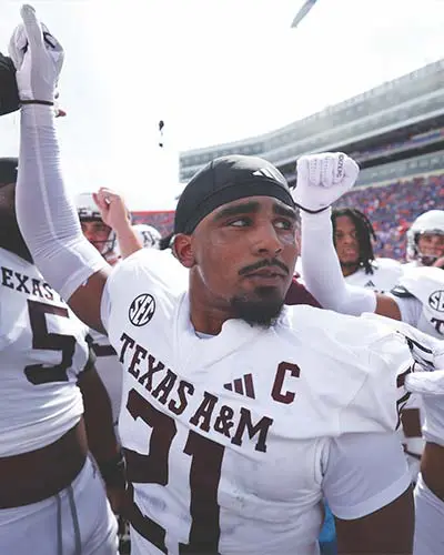 Taurean York in football gear with arm up