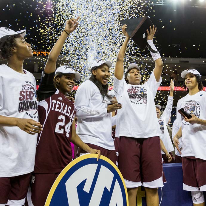 Women's basketball team holding up an SEC trophy