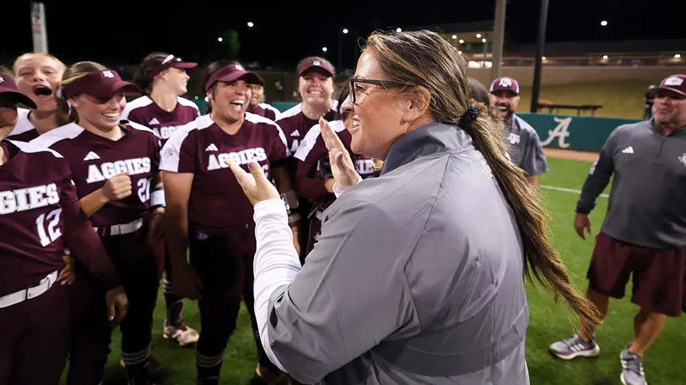 a coach clapping in front of her players