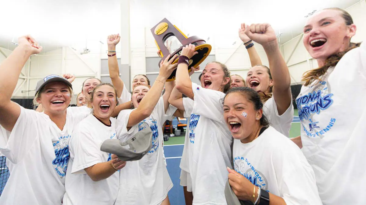 Teammates cheering with trophy