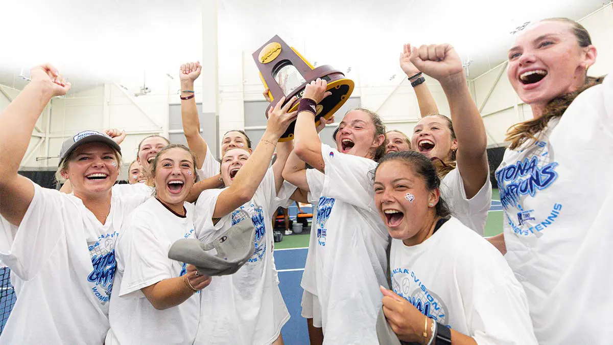 Teammates cheering with trophy